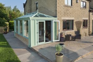 A modern green conservatory for a Surrey home.